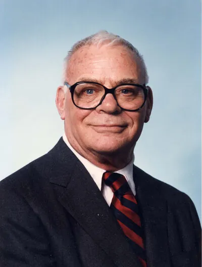 Portrait of John Wolbach in a dark suit and striped tie