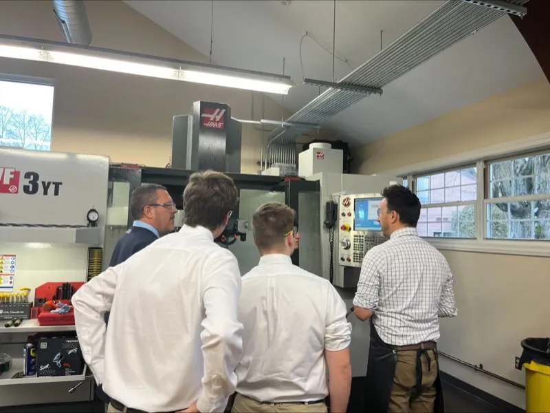 Students in lab coats working in the science lab