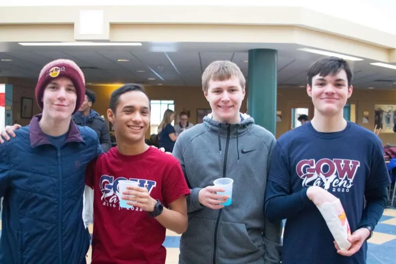 Students bundled up and laughing at Winter Carnival