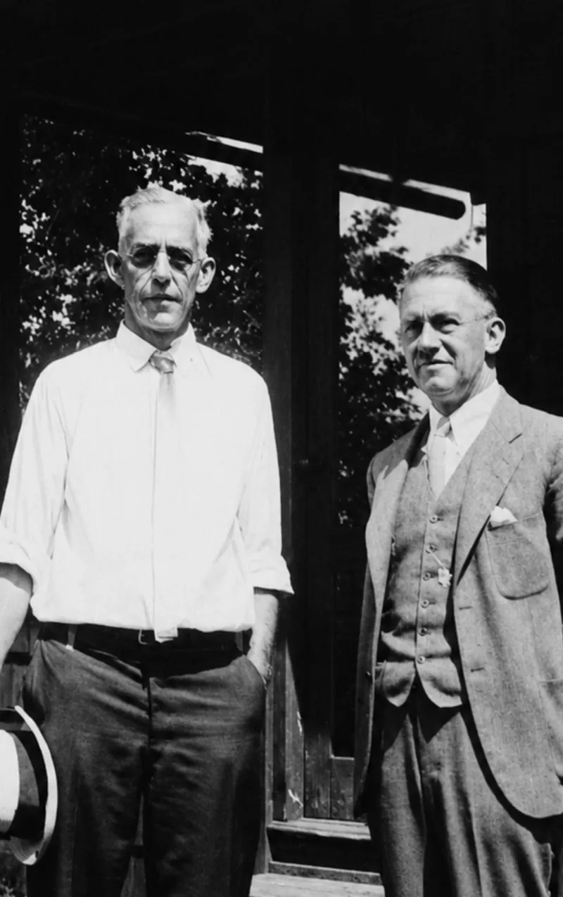Dr. Samuel T. Orton and Peter Gow, Jr. standing side by side outdoors in 1929, Orton in shirtsleeves holding a hat and Gow in a three-piece suit
