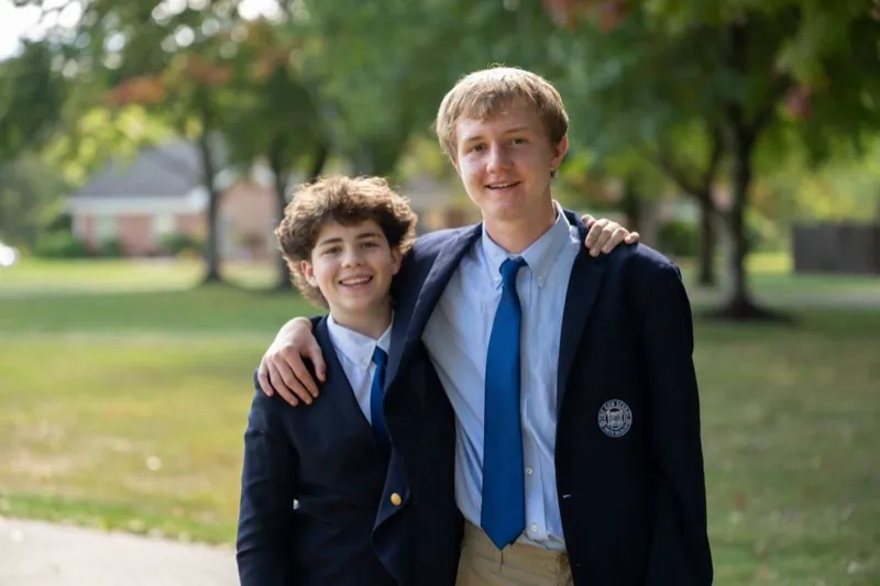 Two boarding students in blazers walking together